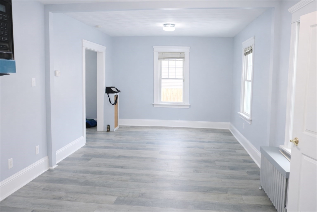 144 Washington Street Springfield, MA 01108 - Photo 5 of 18 wooden floor in an empty room with a window