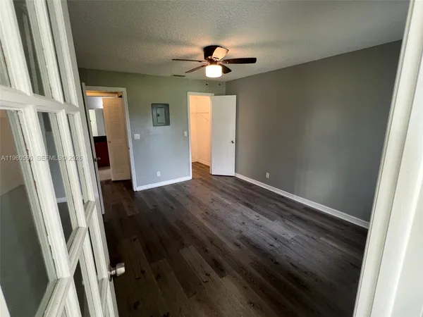 en empty room with wooden floor and window