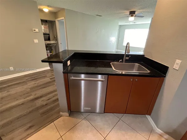 a close view of a sink a mirror and window in a room
