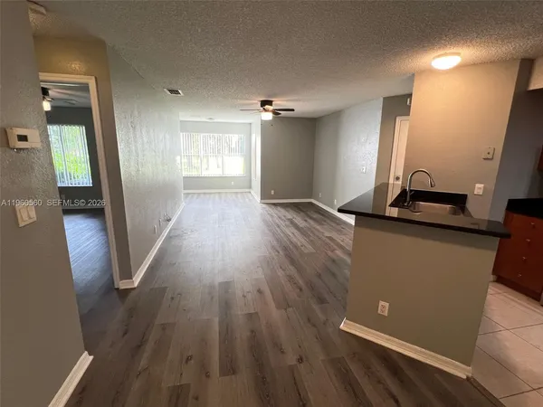wooden floor in an empty room with a mirror