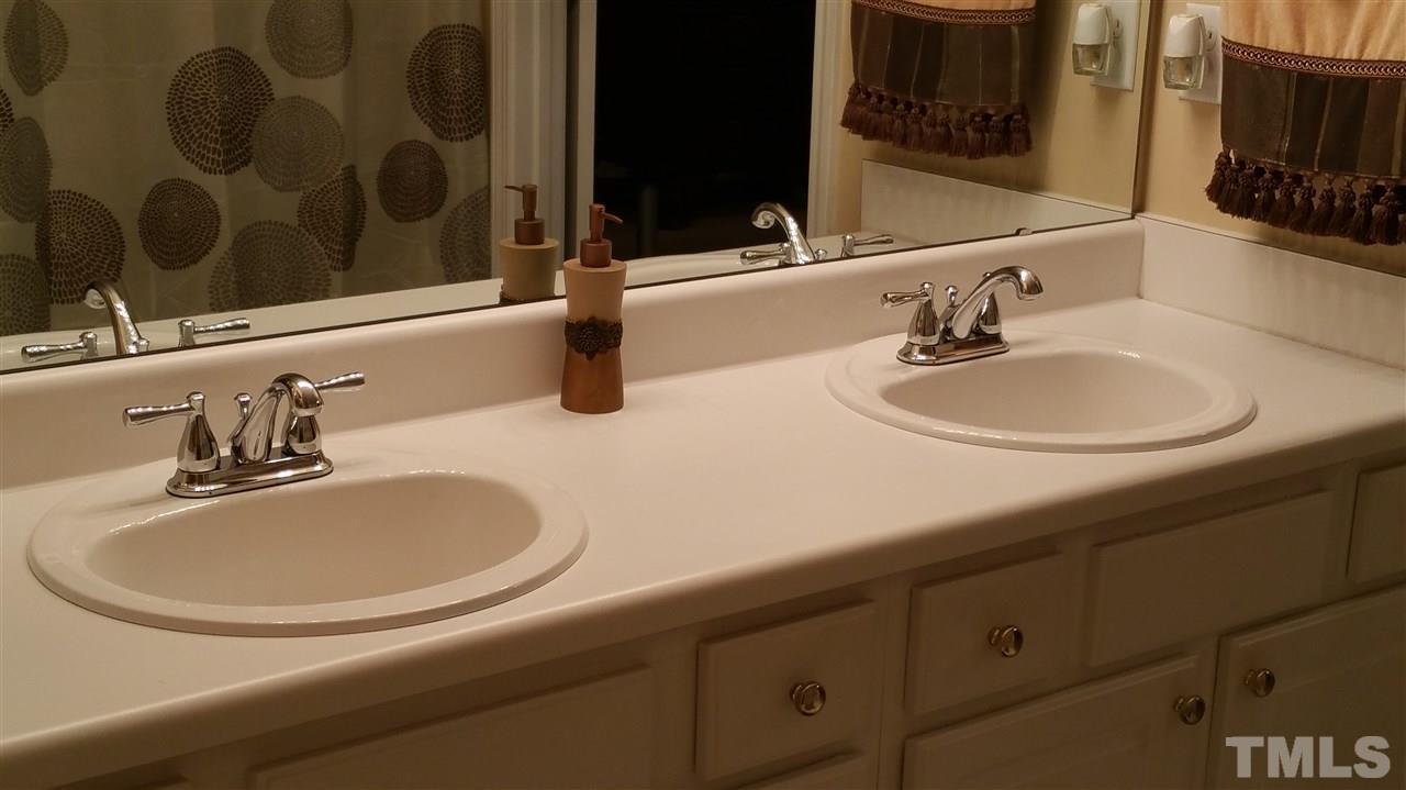 2901 Trassacks Drive Raleigh, NC 27610 - Photo 3 of 14 a bathroom with a sink and a mirror