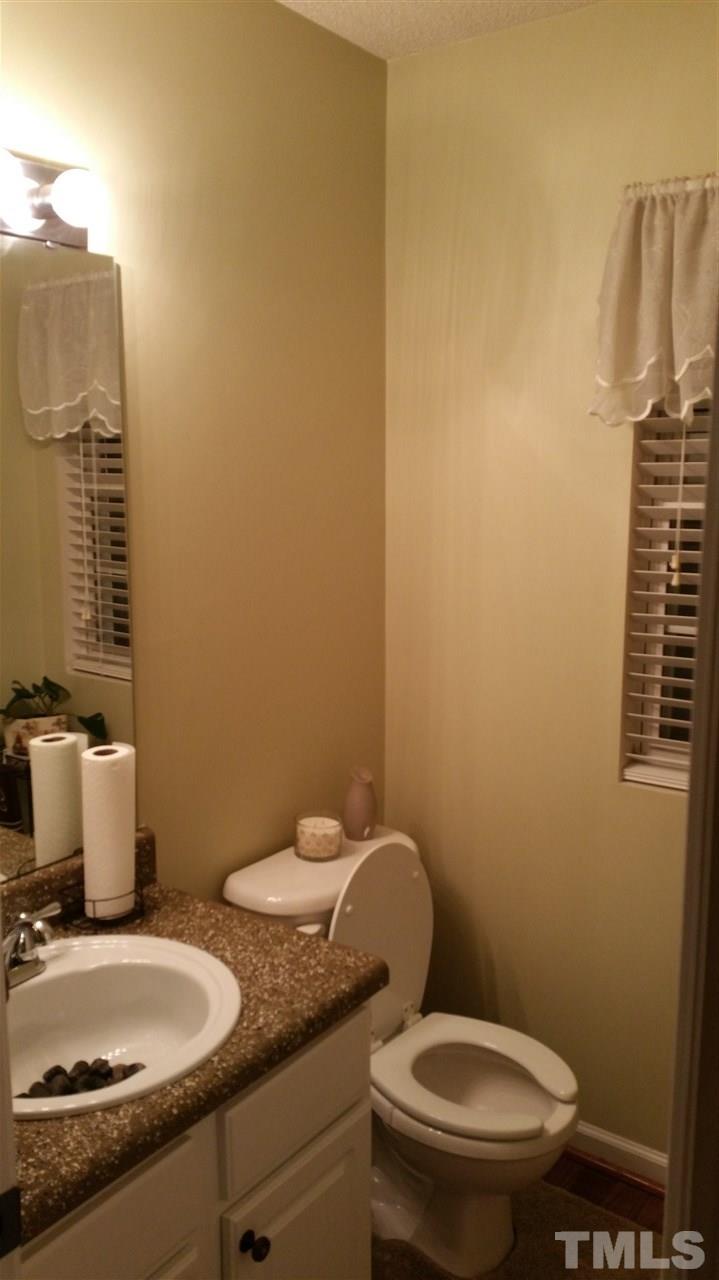 2901 Trassacks Drive Raleigh, NC 27610 - Photo 5 of 14 a bathroom with a granite countertop toilet and a sink