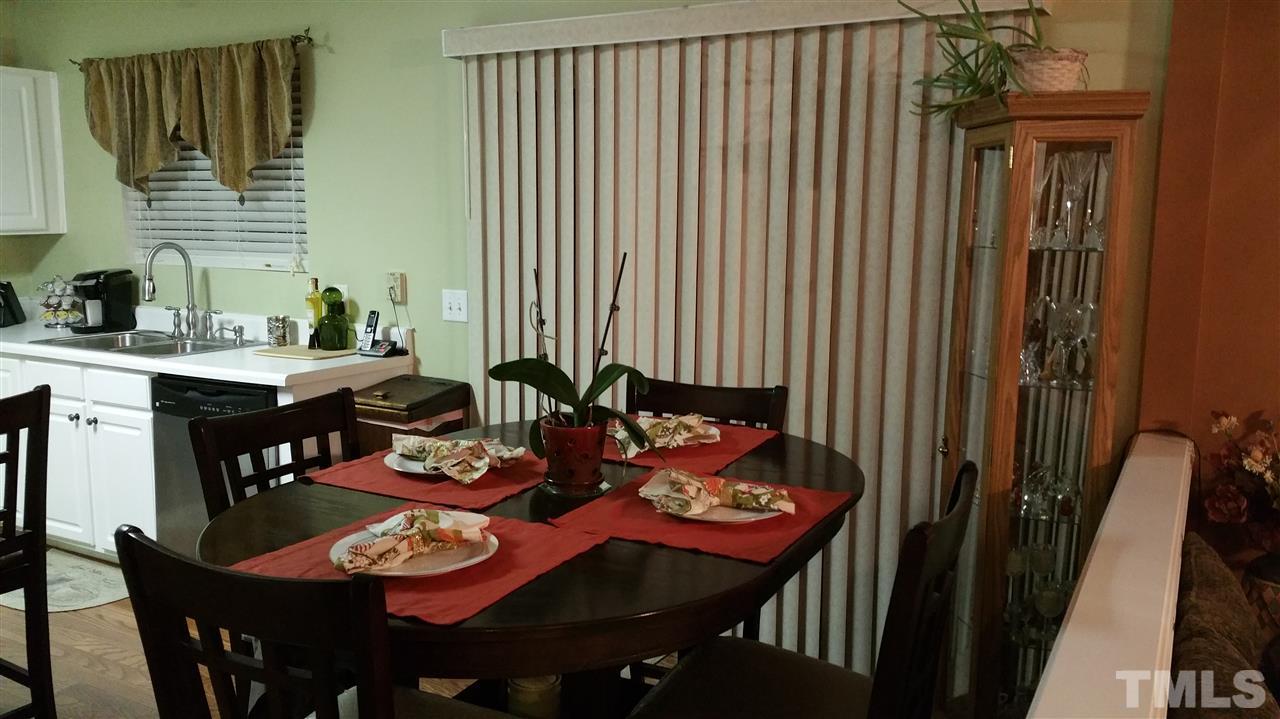 2901 Trassacks Drive Raleigh, NC 27610 - Photo 7 of 14 a outdoor dining space with furniture and a potted plant
