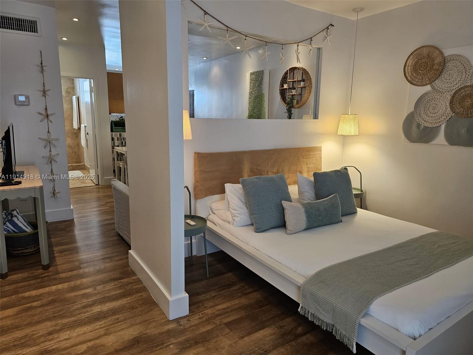 751 Collins Avenue, Unit 3 Miami Beach, FL 33139 - Photo 11 of 35 a bedroom with a bed and cabinets