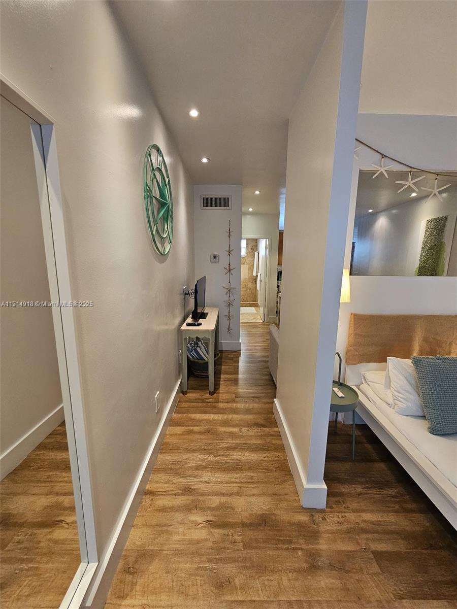 751 Collins Avenue, Unit 3 Miami Beach, FL 33139 - Photo 12 of 35 a view of a hallway with wooden floor and staircase