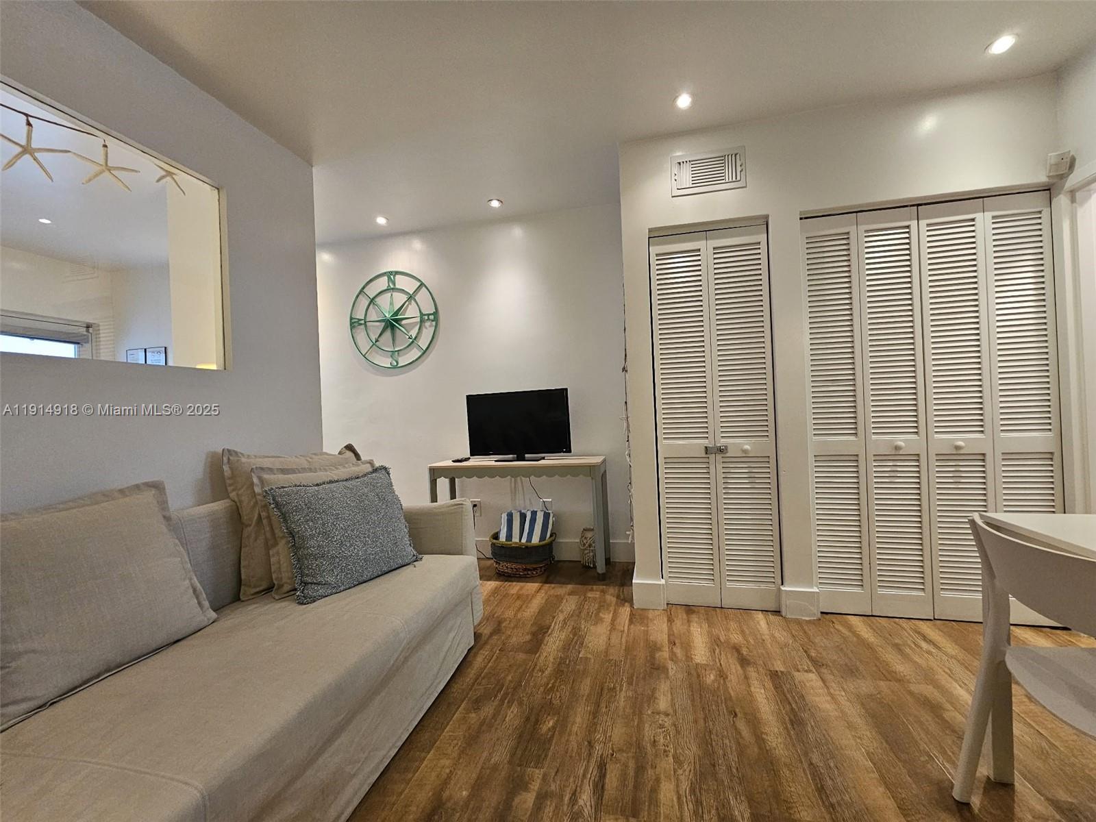 751 Collins Avenue, Unit 3 Miami Beach, FL 33139 - Photo 15 of 35 a living room with furniture and a flat screen tv