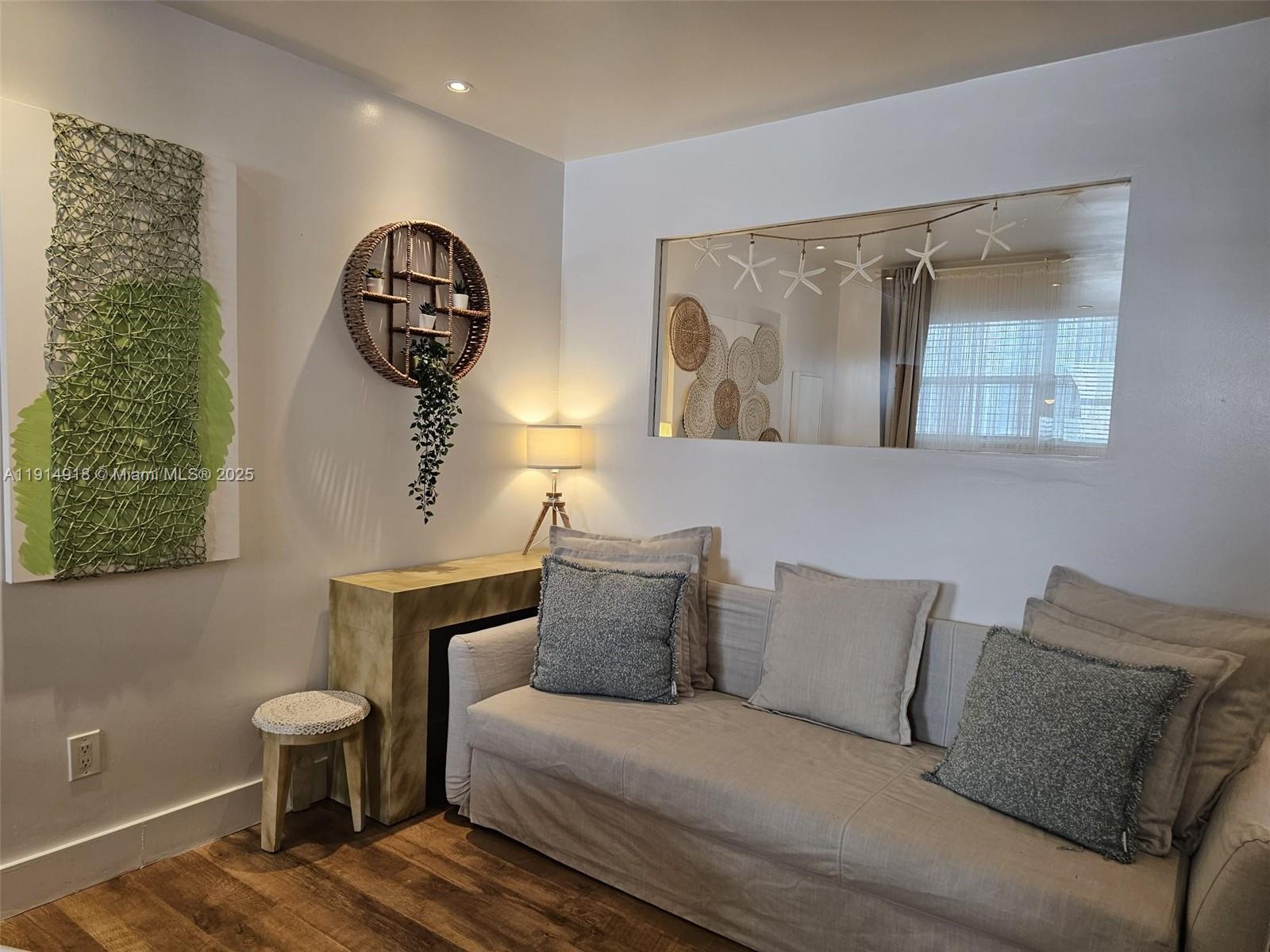 751 Collins Avenue, Unit 3 Miami Beach, FL 33139 - Photo 17 of 35 a living room with furniture and a painting on the wall