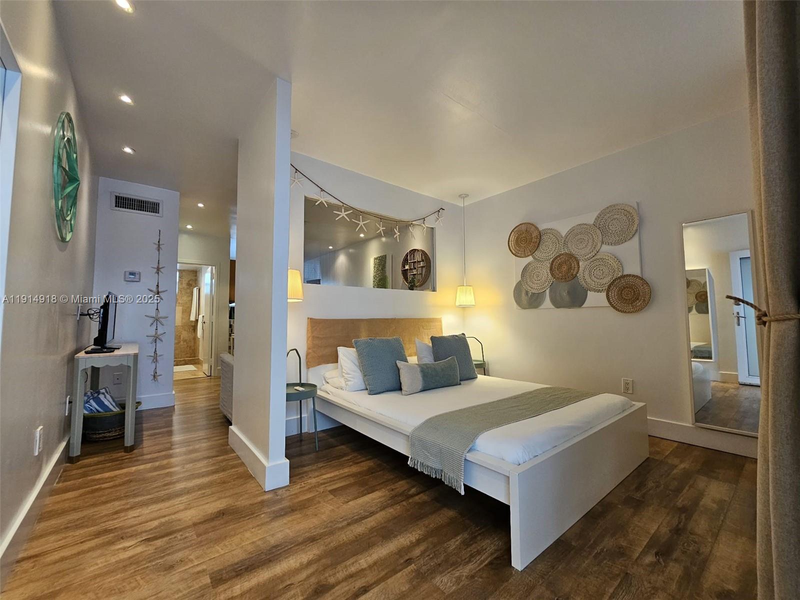 751 Collins Avenue, Unit 3 Miami Beach, FL 33139 - Photo 2 of 35 a living room with furniture and a wooden floor