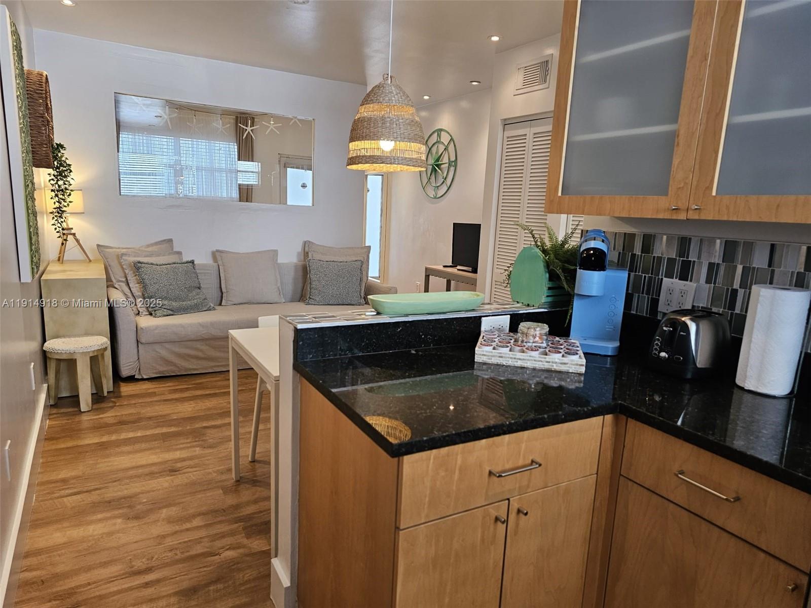 751 Collins Avenue, Unit 3 Miami Beach, FL 33139 - Photo 22 of 35 a kitchen with stainless steel appliances granite countertop a sink and a white cabinets