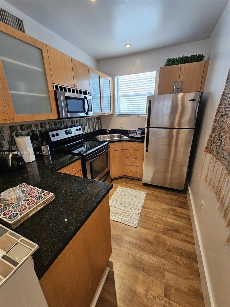 751 Collins Avenue, Unit 3 Miami Beach, FL 33139 - Photo 25 of 35 a kitchen with refrigerator and stove