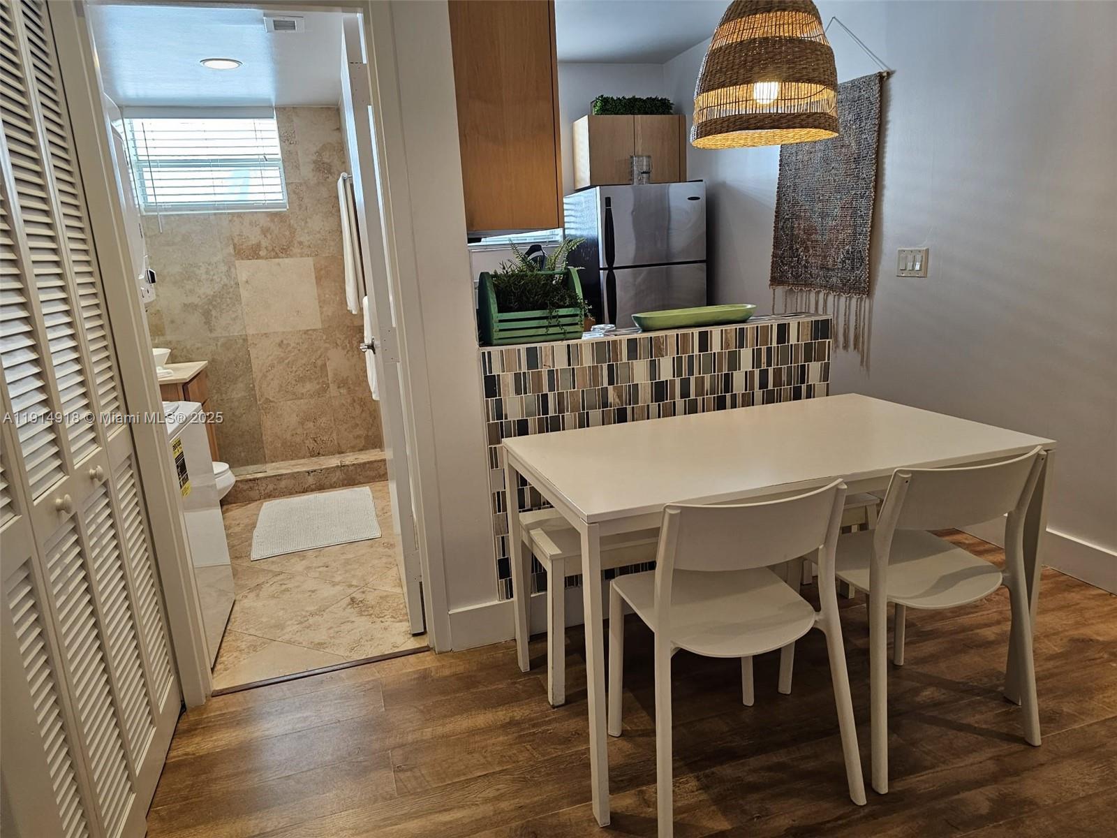 751 Collins Avenue, Unit 3 Miami Beach, FL 33139 - Photo 28 of 35 a view of a dining room with furniture and wooden floor