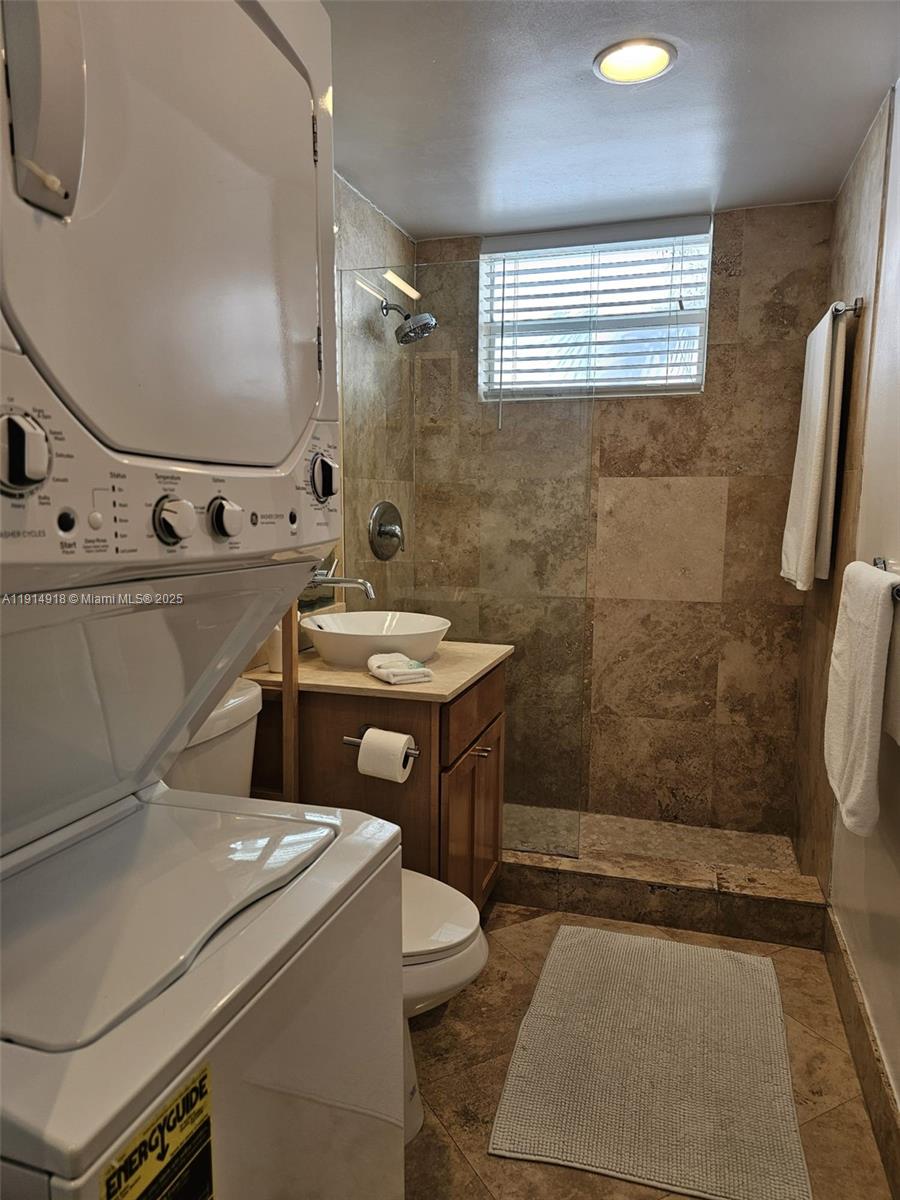 751 Collins Avenue, Unit 3 Miami Beach, FL 33139 - Photo 30 of 35 a bathroom with a sink a toilet and shower