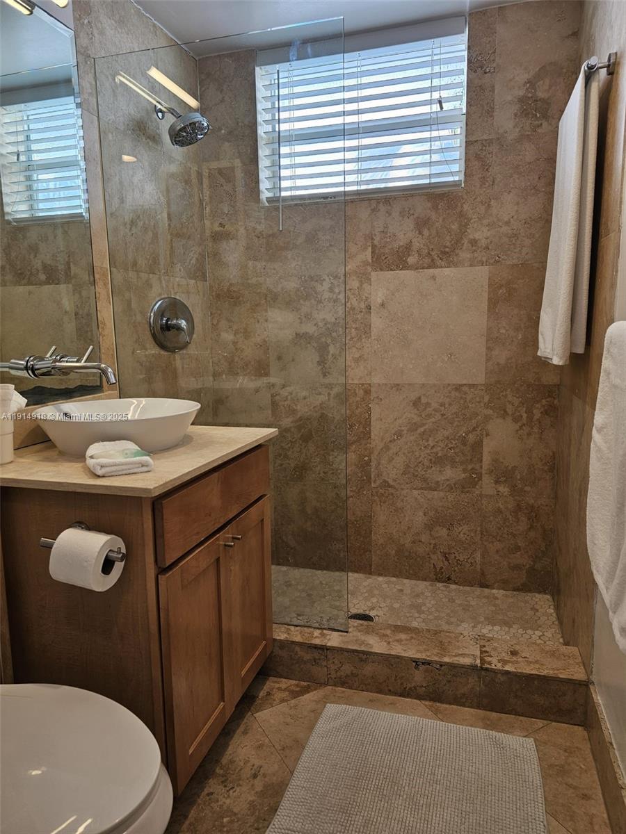 751 Collins Avenue, Unit 3 Miami Beach, FL 33139 - Photo 32 of 35 a bathroom with a sink a toilet and shower