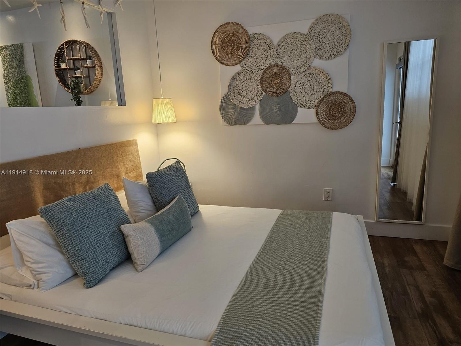 751 Collins Avenue, Unit 3 Miami Beach, FL 33139 - Photo 4 of 35 a bed sitting in a bedroom and painting on the wall