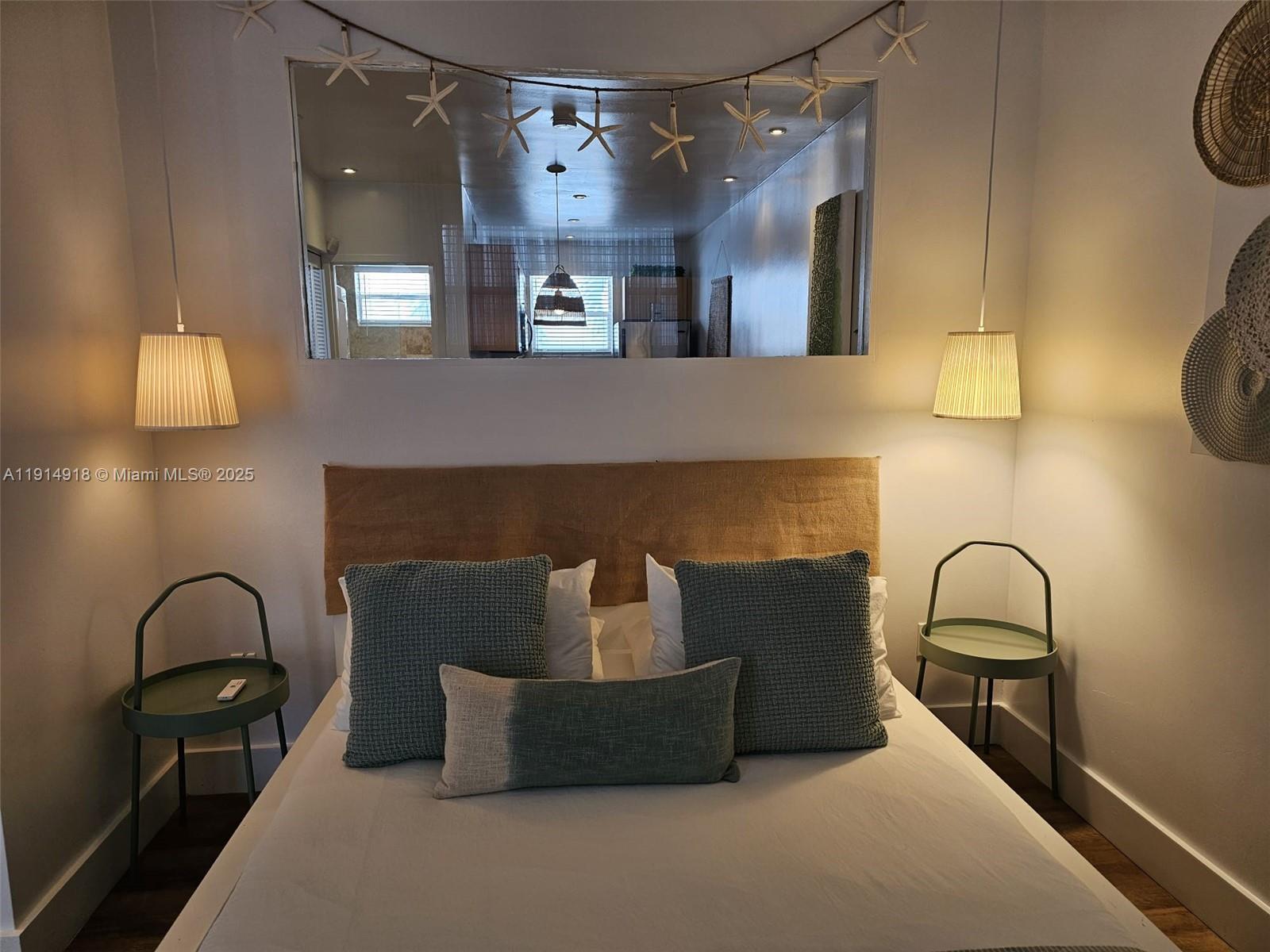 751 Collins Avenue, Unit 3 Miami Beach, FL 33139 - Photo 6 of 35 a living room with furniture and a lamp