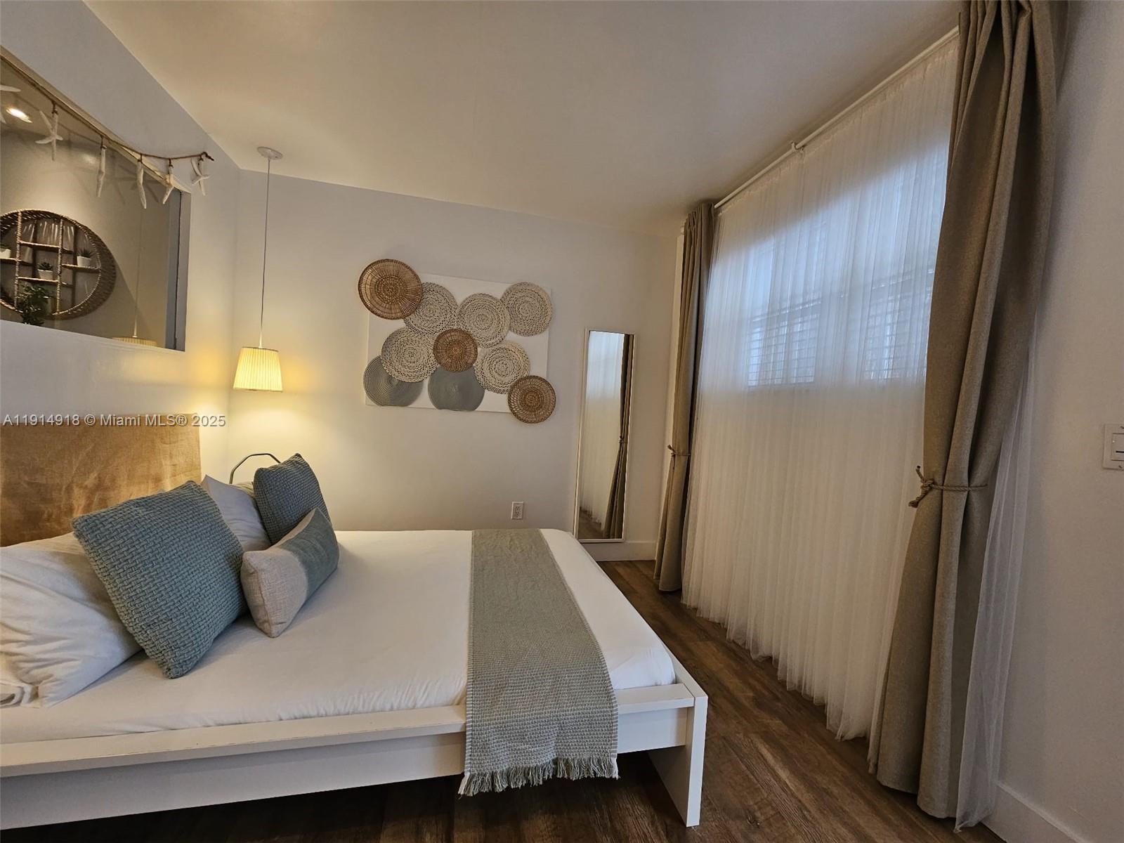 751 Collins Avenue, Unit 3 Miami Beach, FL 33139 - Photo 7 of 35 a bedroom with a bed and a window