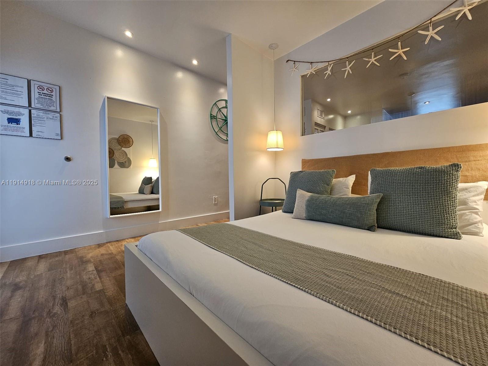 751 Collins Avenue, Unit 3 Miami Beach, FL 33139 - Photo 8 of 35 a spacious bedroom with a bed and a mirror