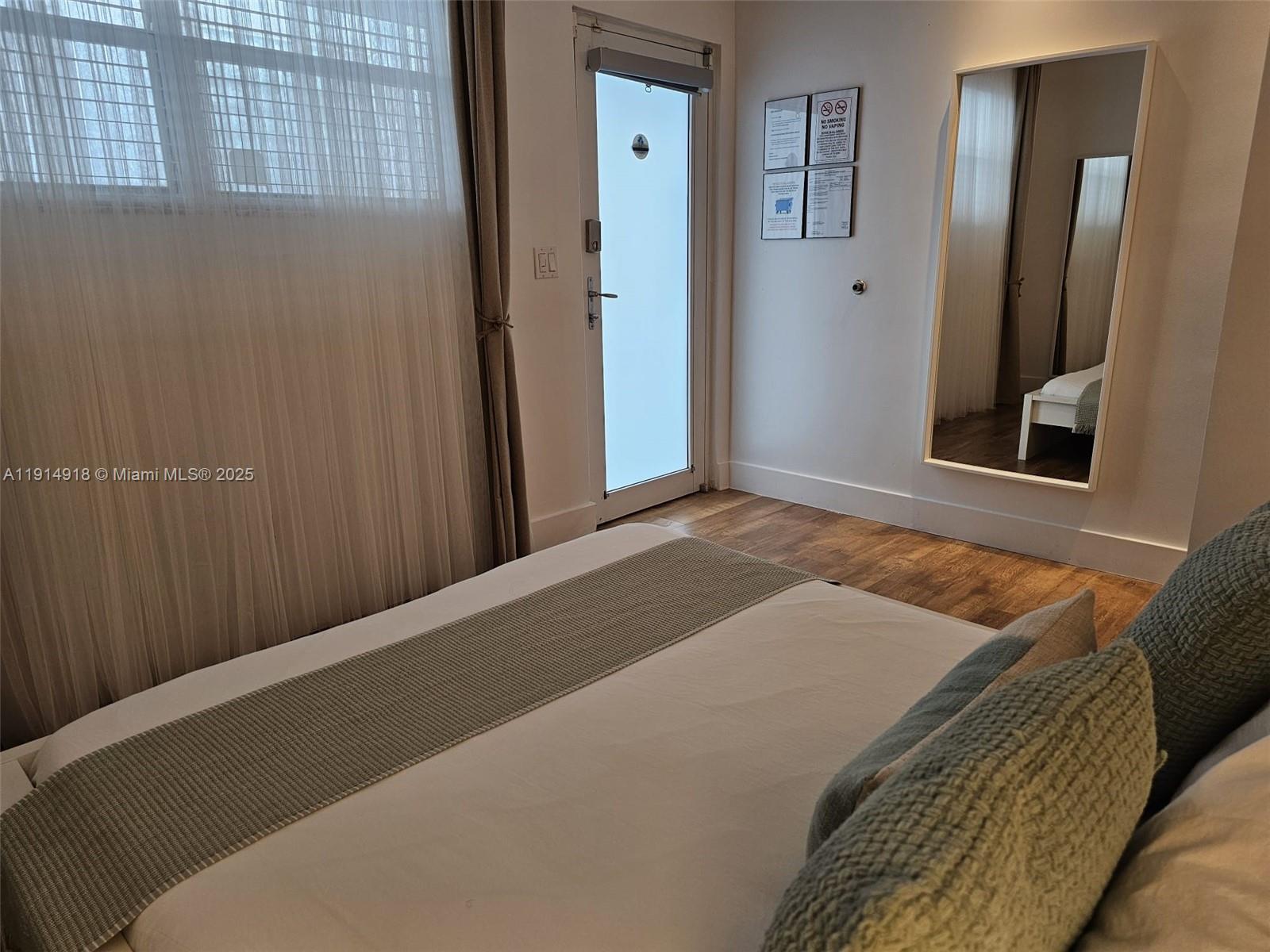 751 Collins Avenue, Unit 3 Miami Beach, FL 33139 - Photo 9 of 35 a bedroom with a bed and a mirror