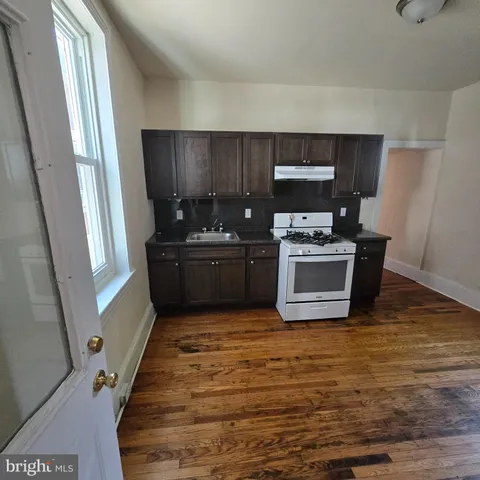 a view of kitchen with stove top oven and cabinets