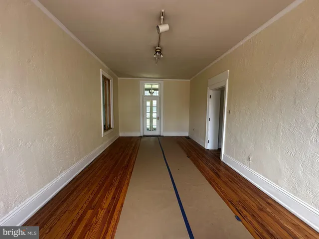 a view of a room with wooden floor