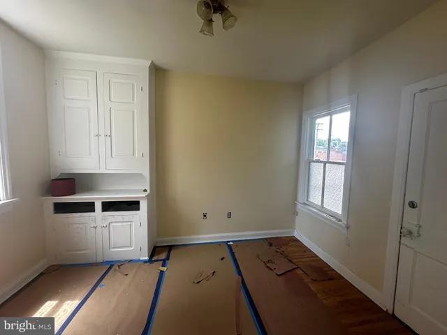 a room with a dresser and a window