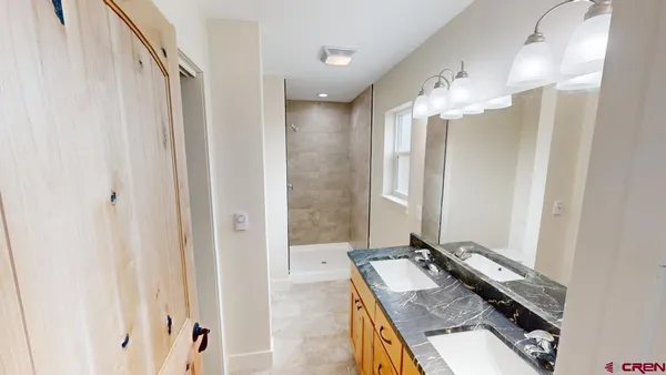 a bathroom with a mirror and a shower