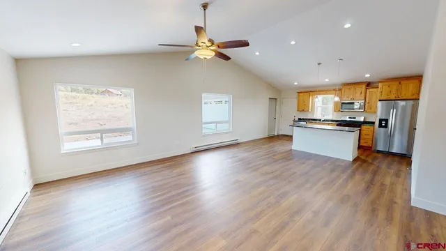 a view of a kitchen with a sink cabinets and wooden floor