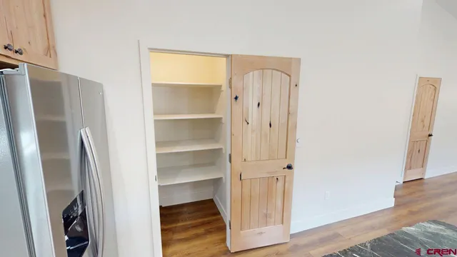 a view of walk in closet with empty racks