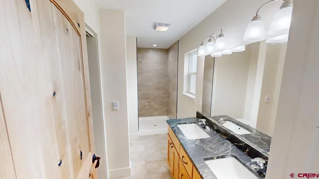 a bathroom with a mirror and a shower