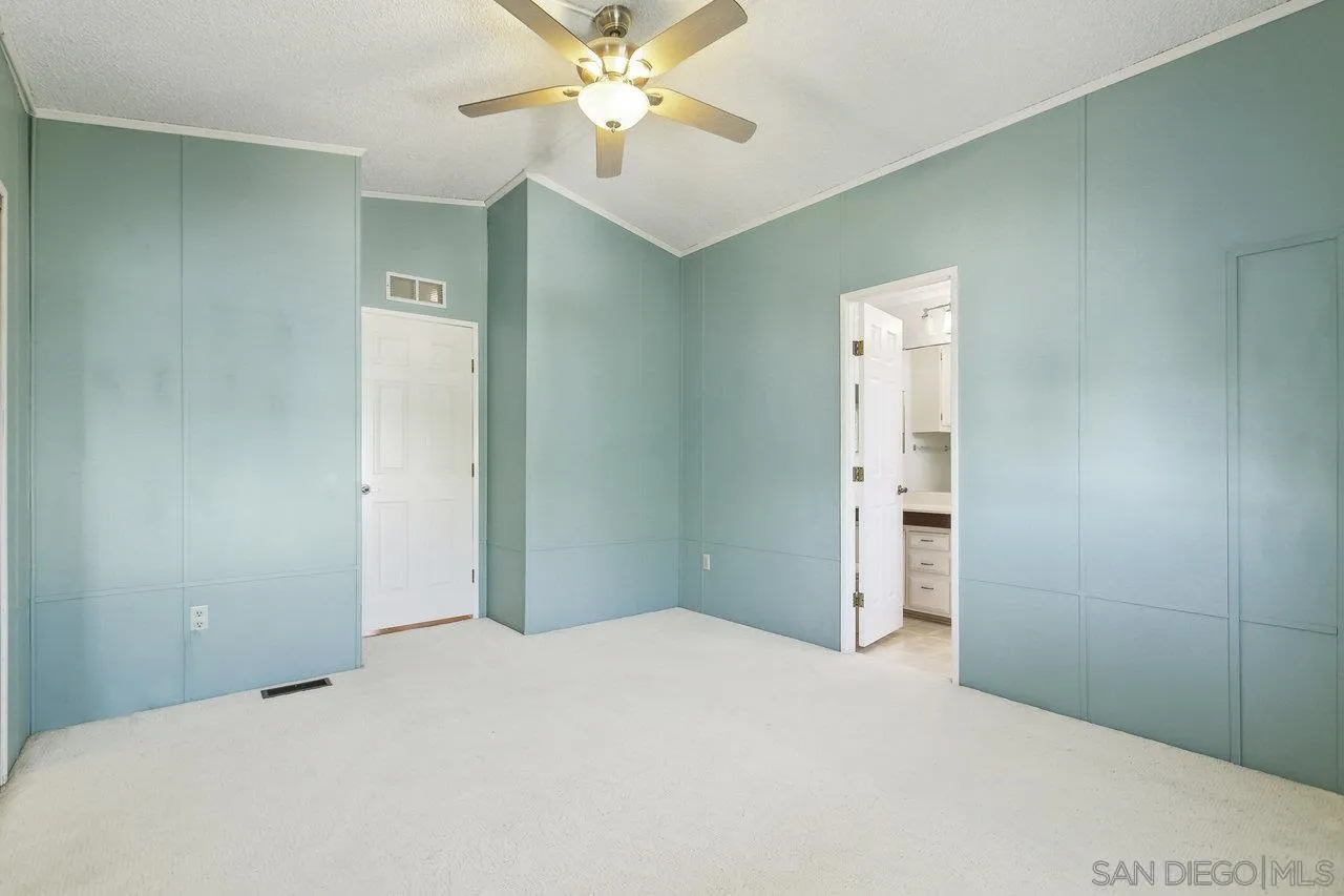 11949 Riverside Drive, Unit SPC 8 Lakeside, CA 92040 - Photo 16 of 29 a bedroom with a bed and a chandelier