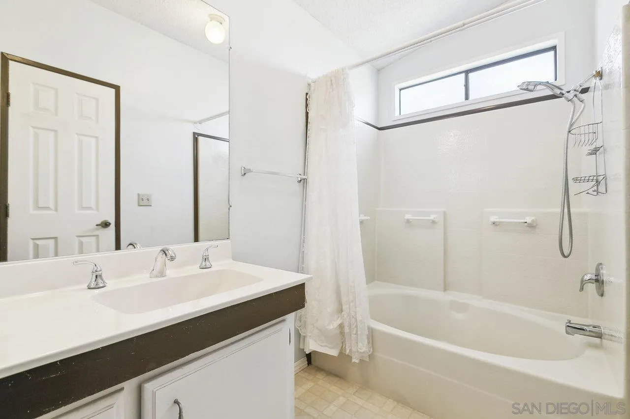 11949 Riverside Drive, Unit SPC 8 Lakeside, CA 92040 - Photo 17 of 29 a bathroom with a bathtub a shower a sink and a mirror