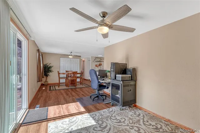 a workspace with wooden floor and a window