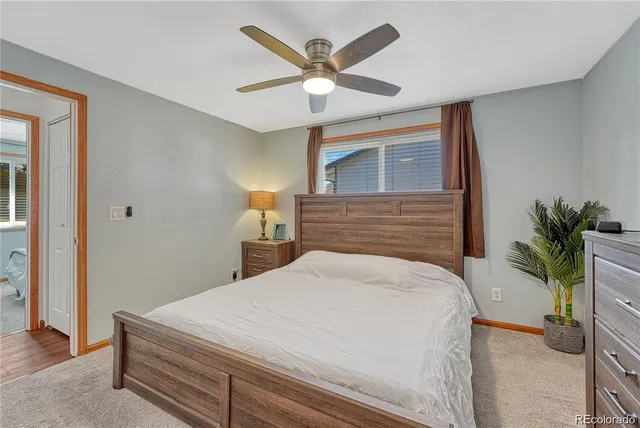 a bedroom with a bed and ceiling fan