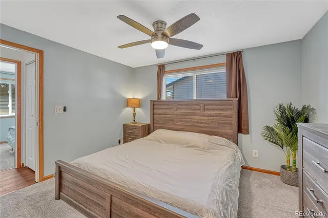 a bedroom with a bed and a potted plant