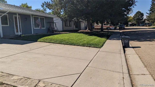 a front view of a house with a yard table and chairs