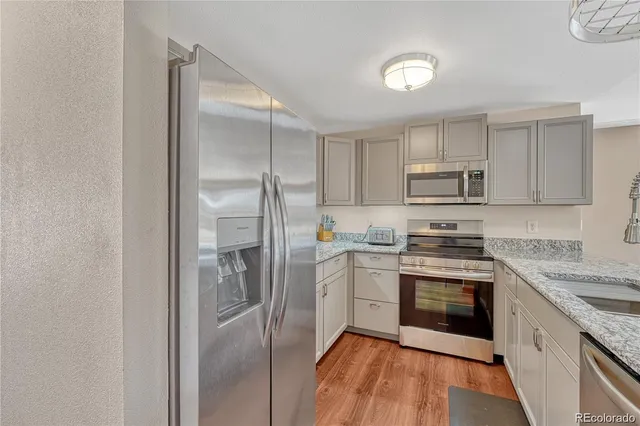 a kitchen with a refrigerator stove and sink