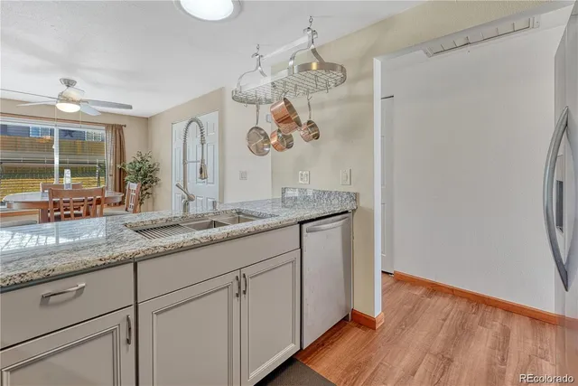 a bathroom with a granite countertop sink a mirror and shower
