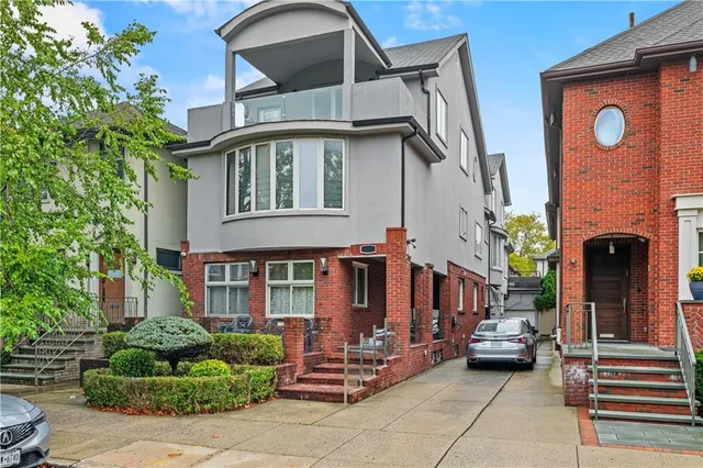 a front view of a house with a garden