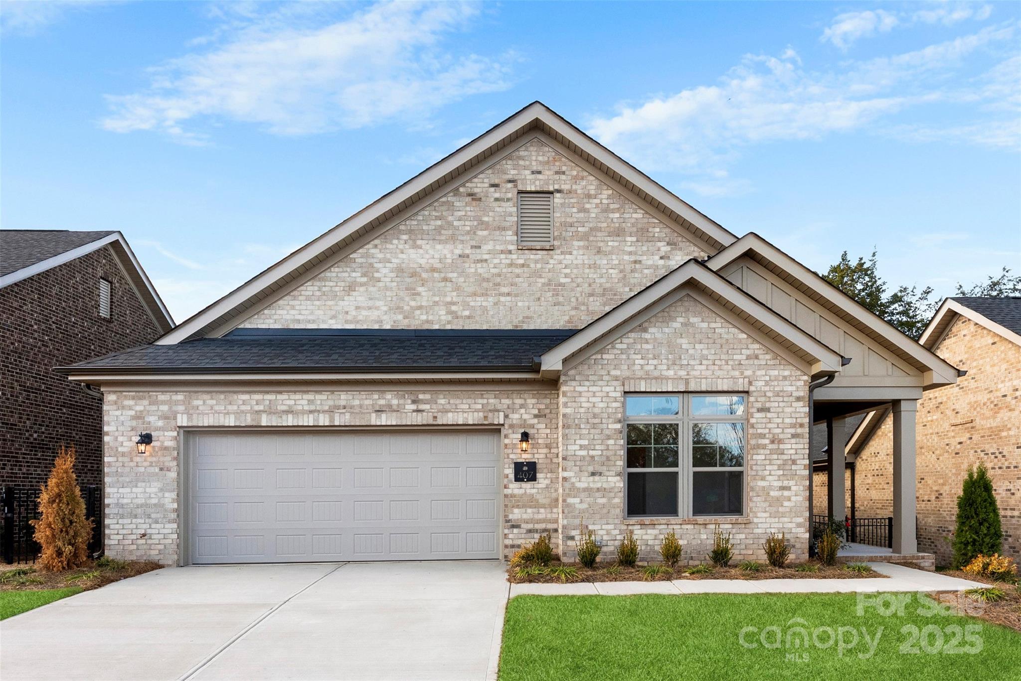a front view of house with a garden