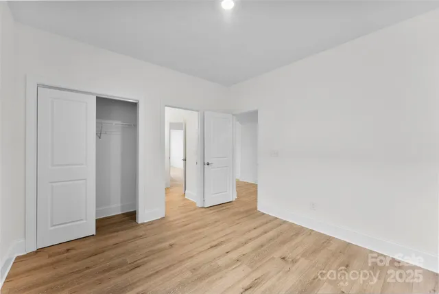 a view of an empty room and wooden floor