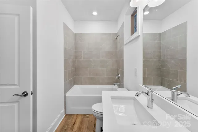 a bathroom with a sink a toilet and bathtub