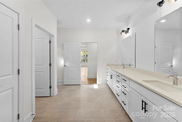 a bathroom with double vanity sink and a mirror