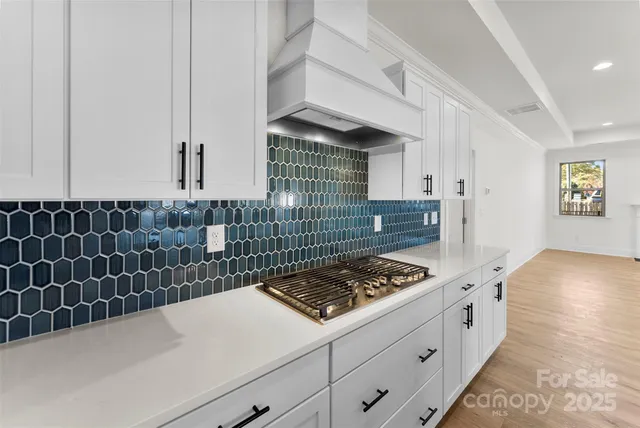 a kitchen with a stove and cabinets