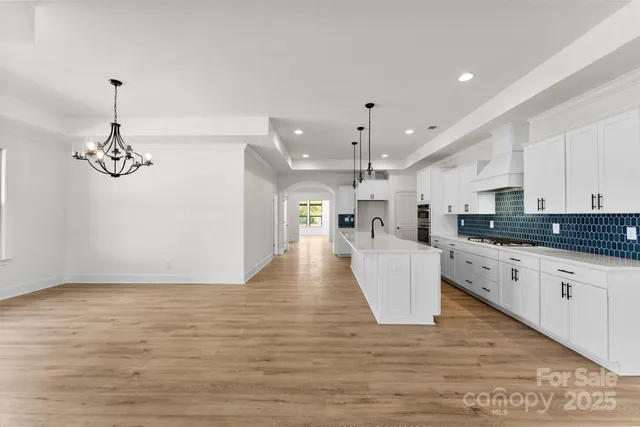 a view of kitchen and kitchen with stainless steel appliances