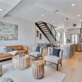 a living room with furniture and a ceiling fan