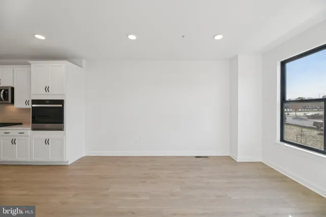 a view of a kitchen with microwave and cabinets