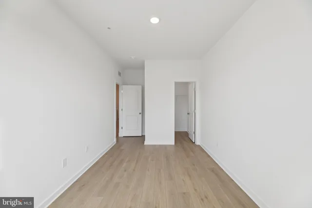 a view of hallway with wooden floor