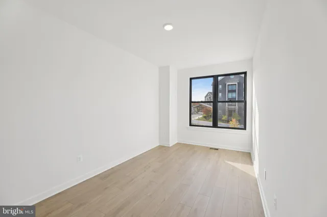 an empty room with windows and closet
