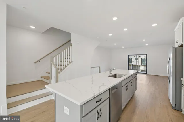 a kitchen with a sink and a stove top oven