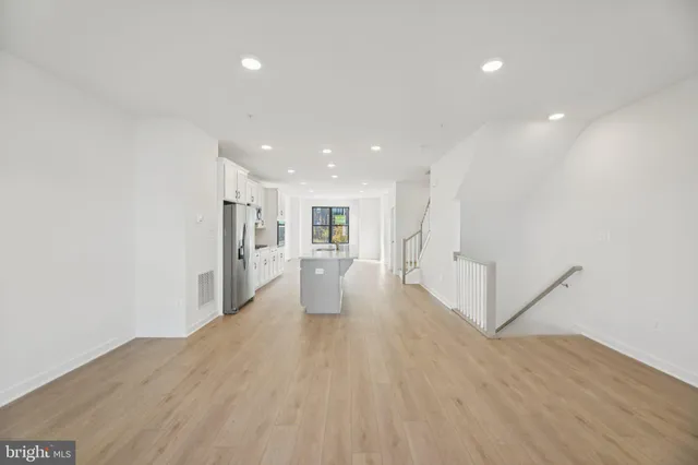 a view of a kitchen with wooden floor